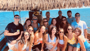 A group posing for a picture while on a tiki boat cruise with Tiki Boat Long Island